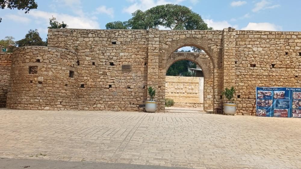 Old stone wall with an arched gateway